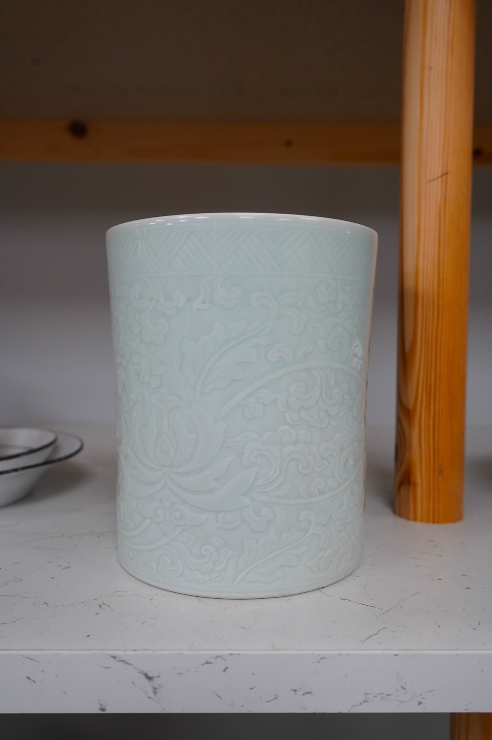 A Chinese celadon glazed brush pot, Kangxi style, 15.5cm high. Condition - good